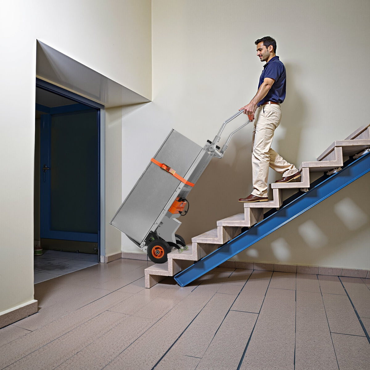 Man using a stair climbing cart to ascend a set of stairs.